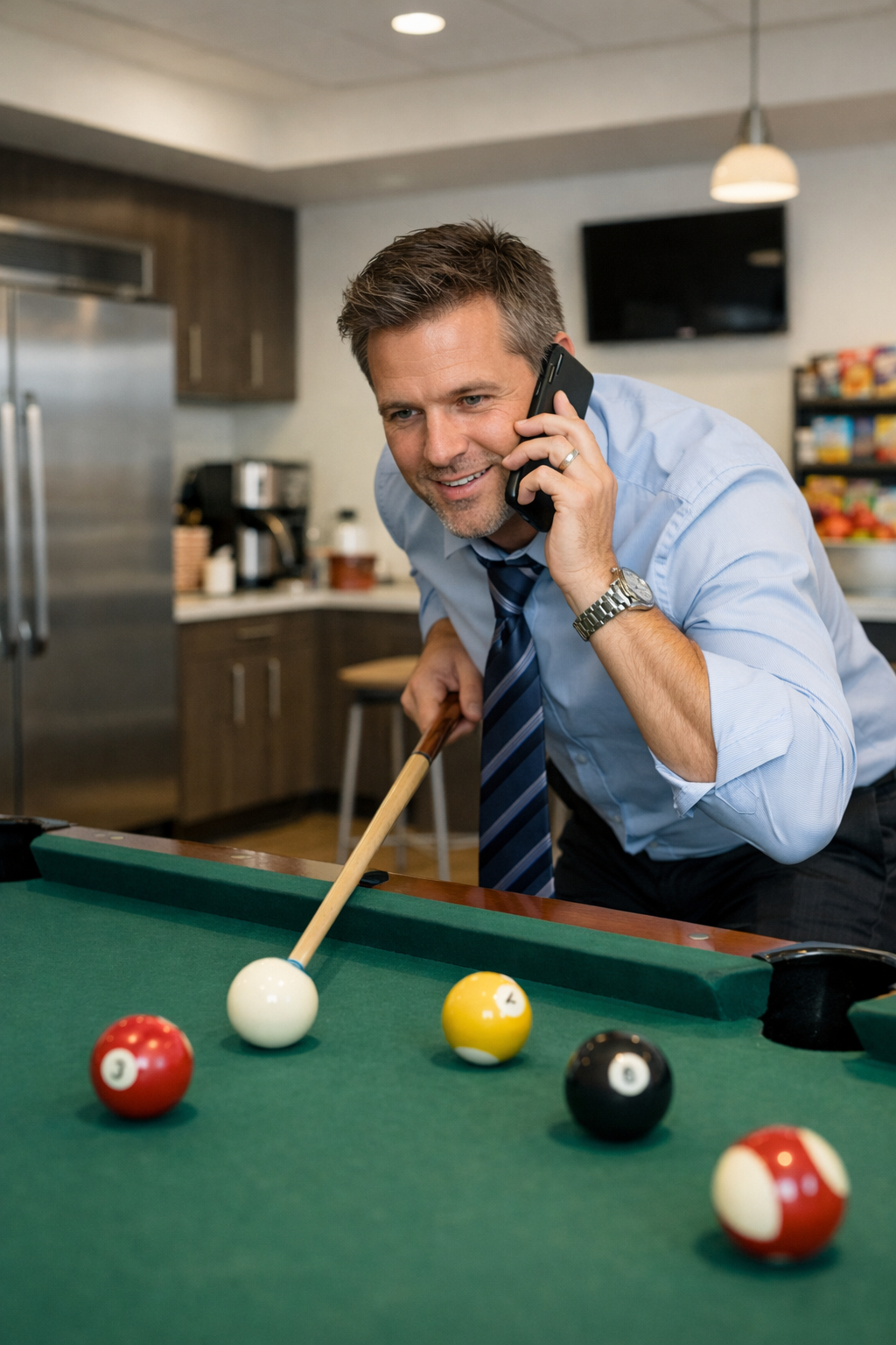 A player on the phone beside a pool table